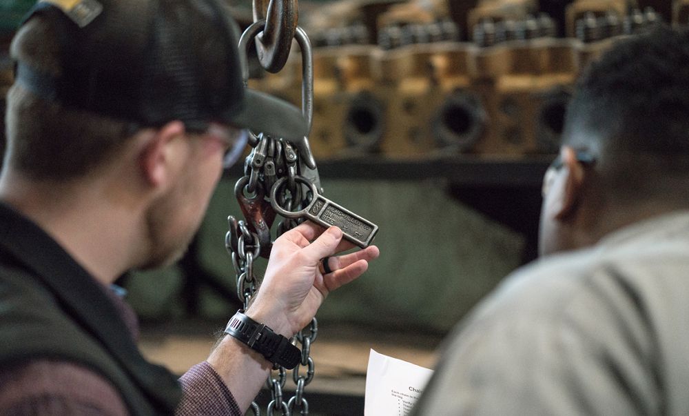 Carter Technician inspecting tag on chain lift